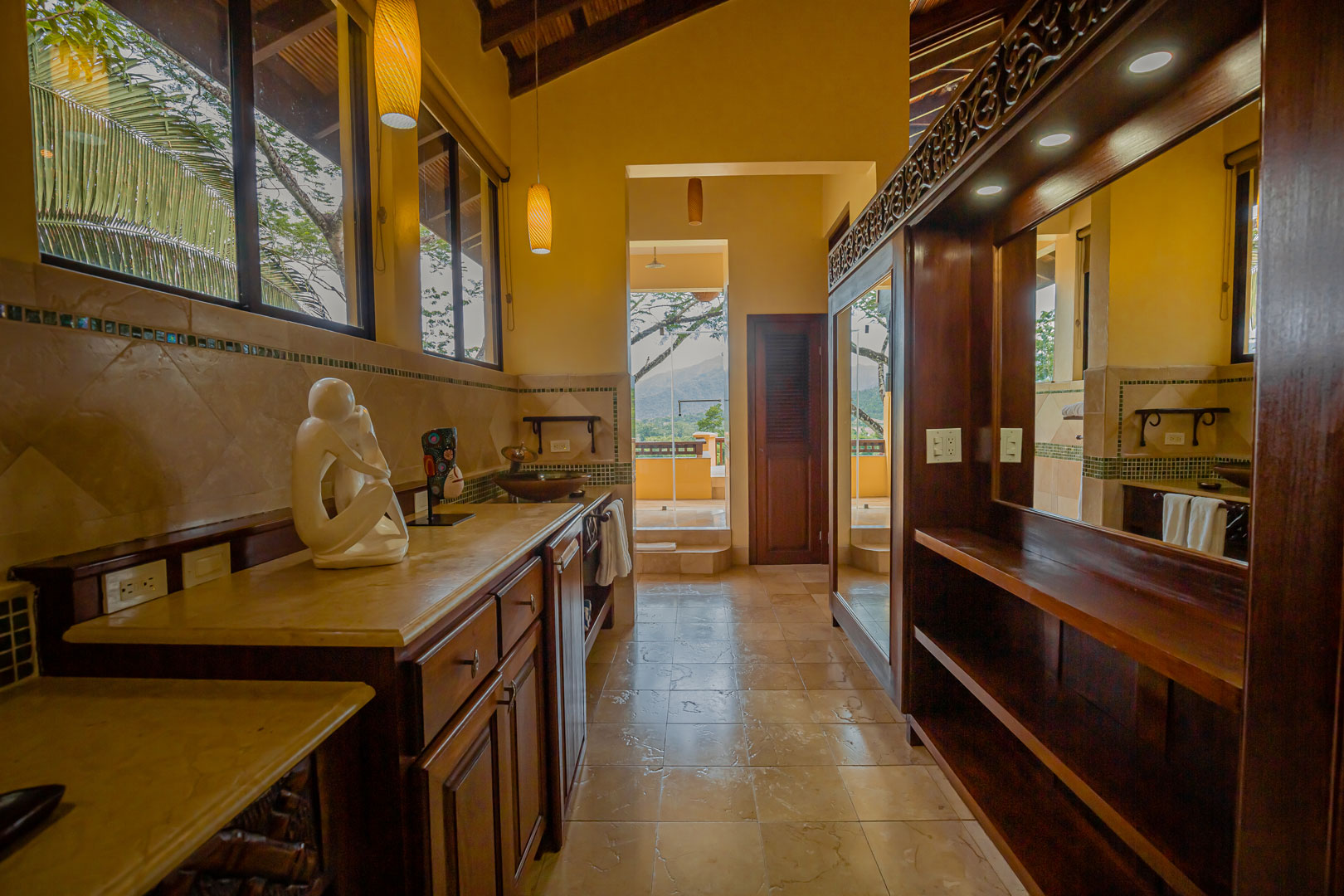 The master bathroom with indoor and outdoor shower inside the Mountain View Penthouse at The Rainforest Lodge at Sleeping Giant