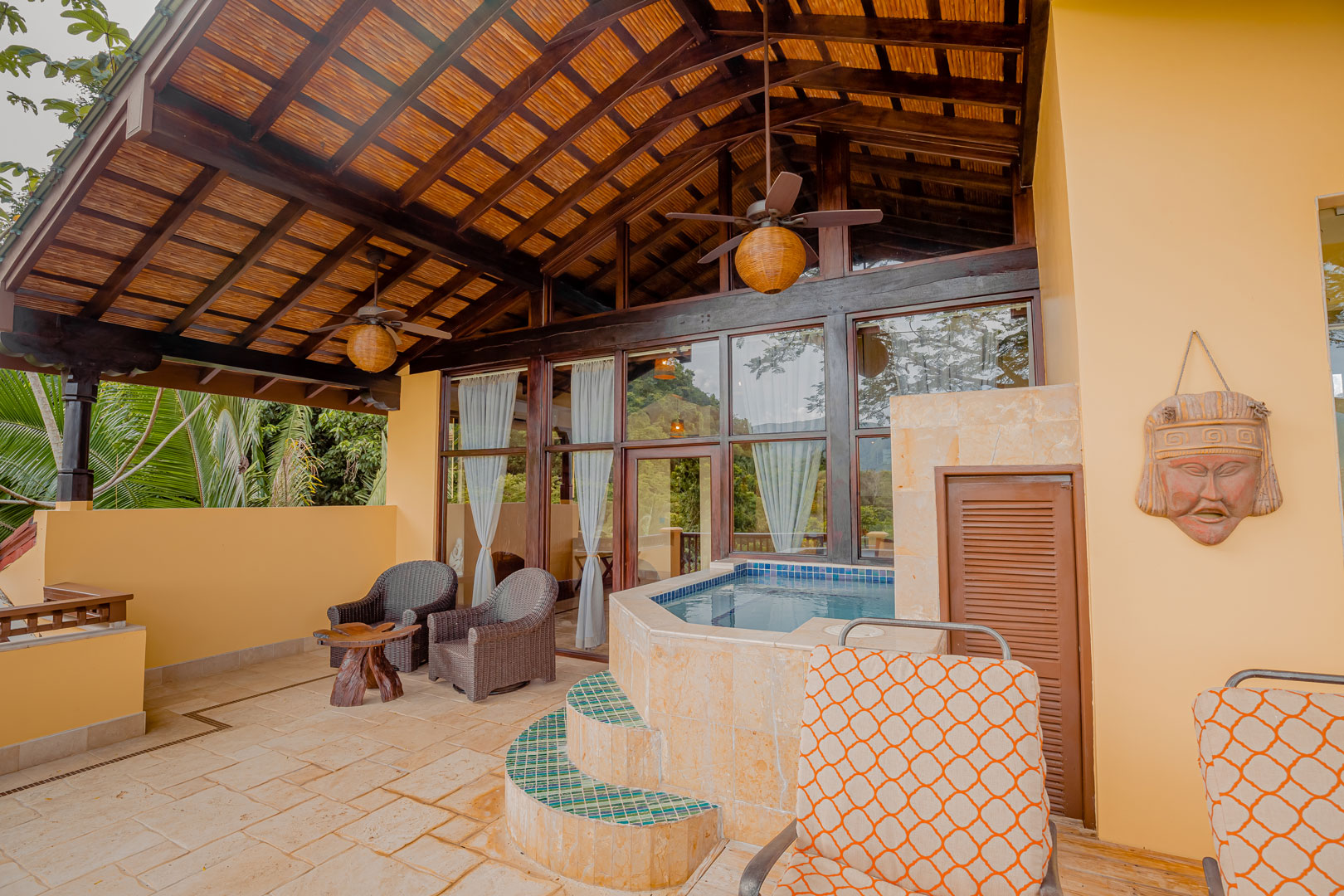 The private balcony with chairs and a private plunge pool outside of the Mountain View Penthouse at The Rainforest Lodge at Sleeping Giant