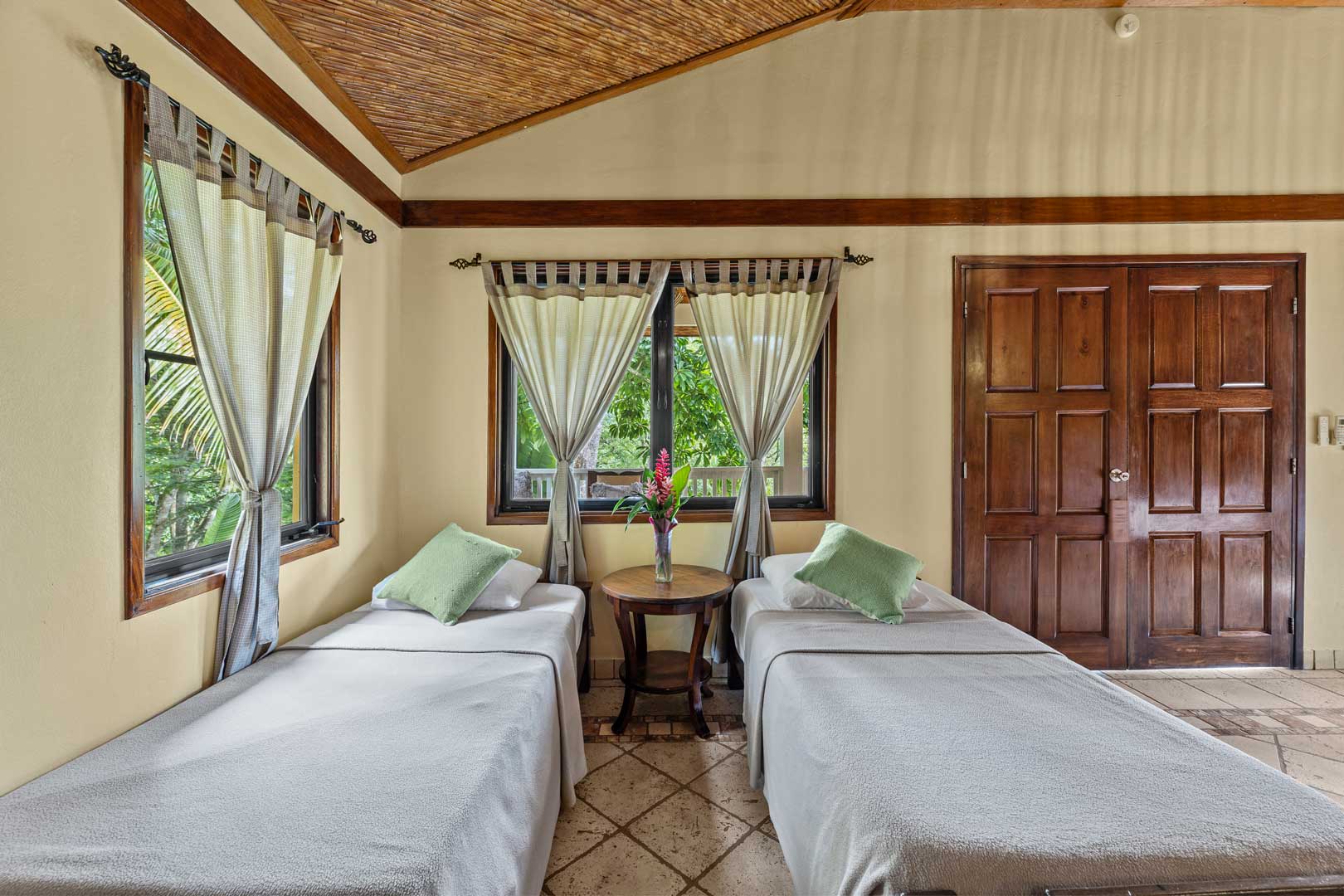 The two single beds inside of the Jungle Cottage with Plunge Pool at The Rainforest Lodge at Sleeping Giant